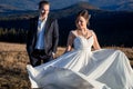 Gorgeous wedding couple posing on the mountain peak. Sunny day Royalty Free Stock Photo