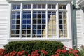 Gorgeous wedding dress hanging from picture window of home