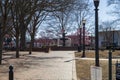 A gorgeous winter landscape at the Marietta Square with red brick footpath, a water fountain, bare trees, pink trees
