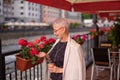 Gorgeous woman is admiring with the wondeful flowers in the coffee shop Royalty Free Stock Photo