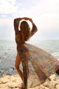 Gorgeous woman with blond hair in elegant swimsuit posing on beach Royalty Free Stock Photo