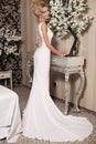 Gorgeous woman with blond hair wears luxurious wedding dress and bijou Royalty Free Stock Photo