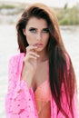 Gorgeous woman with dark hair in elegant swimsuit posing on beach Royalty Free Stock Photo