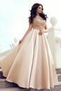 Gorgeous woman with dark hair in luxurious elegant dress