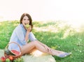 Gorgeous woman eating an apple in the park