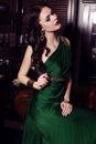 Gorgeous woman in elegant green dress posing in luxurious interior Royalty Free Stock Photo