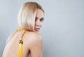 Gorgeous woman with fashion jewellery accessories long necklace. Female back. Blonde model lady Royalty Free Stock Photo