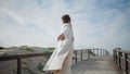Gorgeous woman open arms walking pier. Cheerful curly african american spinning Royalty Free Stock Photo