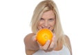 Gorgeous woman with an orange in her outstretch arm