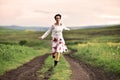 Gorgeous woman running on a countryside road Royalty Free Stock Photo