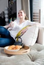 Gorgeous woman sitting on comfortable sofa for happy morning time Royalty Free Stock Photo