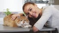 Gorgeous woman smiling posing with her cat at the vet office Royalty Free Stock Photo