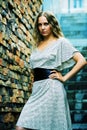 Young fashion gorgeous woman in white dress on steps Royalty Free Stock Photo