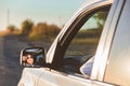 gorgeous woman in sunglasses reflection in car mirror on sunset Royalty Free Stock Photo