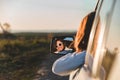 gorgeous woman in sunglasses reflection in car mirror on sunset Royalty Free Stock Photo