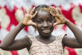 Gorgeous young African girl showing palms as peace symbol portrait