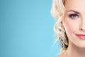 Gorgeous, young blond wearing sapphire crown and earrings over g Royalty Free Stock Photo