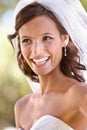 Shes a blushing bride. Gorgeous young bride looking away in her wedding dress and veil. Royalty Free Stock Photo