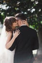 Gorgeous young bride and stylish groom are hugging on wedding day outdoors, wedding couple, luxury wedding Royalty Free Stock Photo