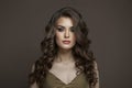 Gorgeous young brunette female model with long brown wavy hair and makeup closeup portrait Royalty Free Stock Photo