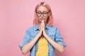 Gorgeous young caucasianwoman in glasses, holding hands in namaste or prayer