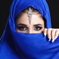 Gorgeous Young East Woman face portrait in hijab. Beauty Model Girl with bright eyebrows, perfect make-up, touching her