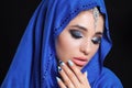 Gorgeous Young East Woman face portrait in hijab. Beauty Model Girl with bright eyebrows, perfect make-up, touching her