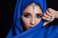 Gorgeous Young East Woman face portrait in hijab. Beauty Model Girl with bright eyebrows, perfect make-up, touching her Royalty Free Stock Photo