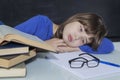 Gorgeous young hardworking student tired among his books while studying Royalty Free Stock Photo