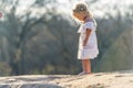 A Lovely Blonde Child Enjoys An Spring Day Outdoors Royalty Free Stock Photo