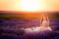 Gorgeous young princess girl in the lavender field at sunset