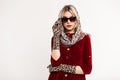 Gorgeous young woman blonde straightens sunglasses. Studio portrait chic girl with sexy lips in fashionable leopard scarf on head