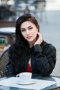 Gorgeous young woman with cup of coffee in city street. Coffee break.  Stylish hipster girl drinking coffee in street. Royalty Free Stock Photo