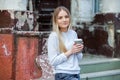 Gorgeous young woman with cup of coffee in city street. Coffee break. Coffee to go. Stylish hipster girl drinking coffee in street Royalty Free Stock Photo