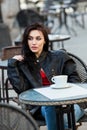 Gorgeous young woman with cup of coffee in city street. Coffee break.  Stylish hipster girl drinking coffee in street. Royalty Free Stock Photo