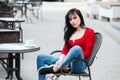 Gorgeous young woman with cup of coffee in city street. Coffee break.  Stylish hipster girl drinking coffee in street. Royalty Free Stock Photo