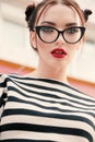 gorgeous young woman with dark hair in casual clothes wears glasses Royalty Free Stock Photo