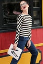 gorgeous young woman with dark hair in casual clothes wears glasses Royalty Free Stock Photo