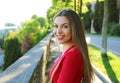 Gorgeous young woman with long hair turn the head and looking at camera when walking in the street Royalty Free Stock Photo