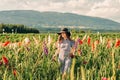 Gorgeous young woman picking flowers in a field Royalty Free Stock Photo