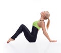 Gorgeous young woman practicing yoga sitting on the floor