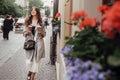 Gorgeous young woman with two cups of coffee smiling and walking Royalty Free Stock Photo