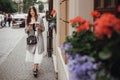 Gorgeous young woman with two cups of coffee smiling and walking Royalty Free Stock Photo