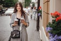 Gorgeous young woman with two cups of coffee smiling and walking Royalty Free Stock Photo