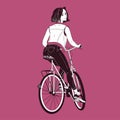 Gorgeous young woman wearing jeans, trainers and vest riding bike. Girl dressed in trendy clothes sitting on bicycle Royalty Free Stock Photo