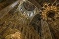 Gorgeously decorated golden altar and frescoes on the walls in interior of Holy Dormition Cathedral in Pechersk Lavra