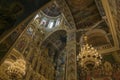 Gorgeously decorated golden altar and frescoes on the walls in interior of Holy Dormition Cathedral in Pechersk Lavra