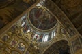 Gorgeously decorated golden altar and frescoes on the walls in interior of Holy Dormition Cathedral in Pechersk Lavra