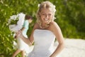 Gorgerous bride walking to wedding ceremony on the beach with bo Royalty Free Stock Photo