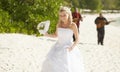 Gorgerous bride walking to wedding ceremony on the beach with bo Royalty Free Stock Photo